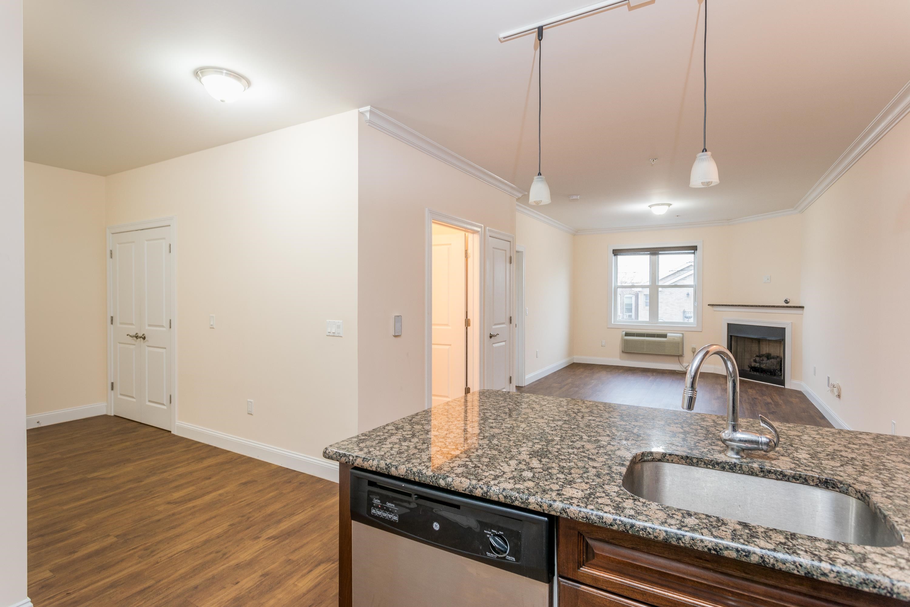 6111 Fillmore Place, Unit 306 West New York, NJ 07093 - Photo 24 of 27 a bathroom with a granite countertop sink a toilet and mirror
