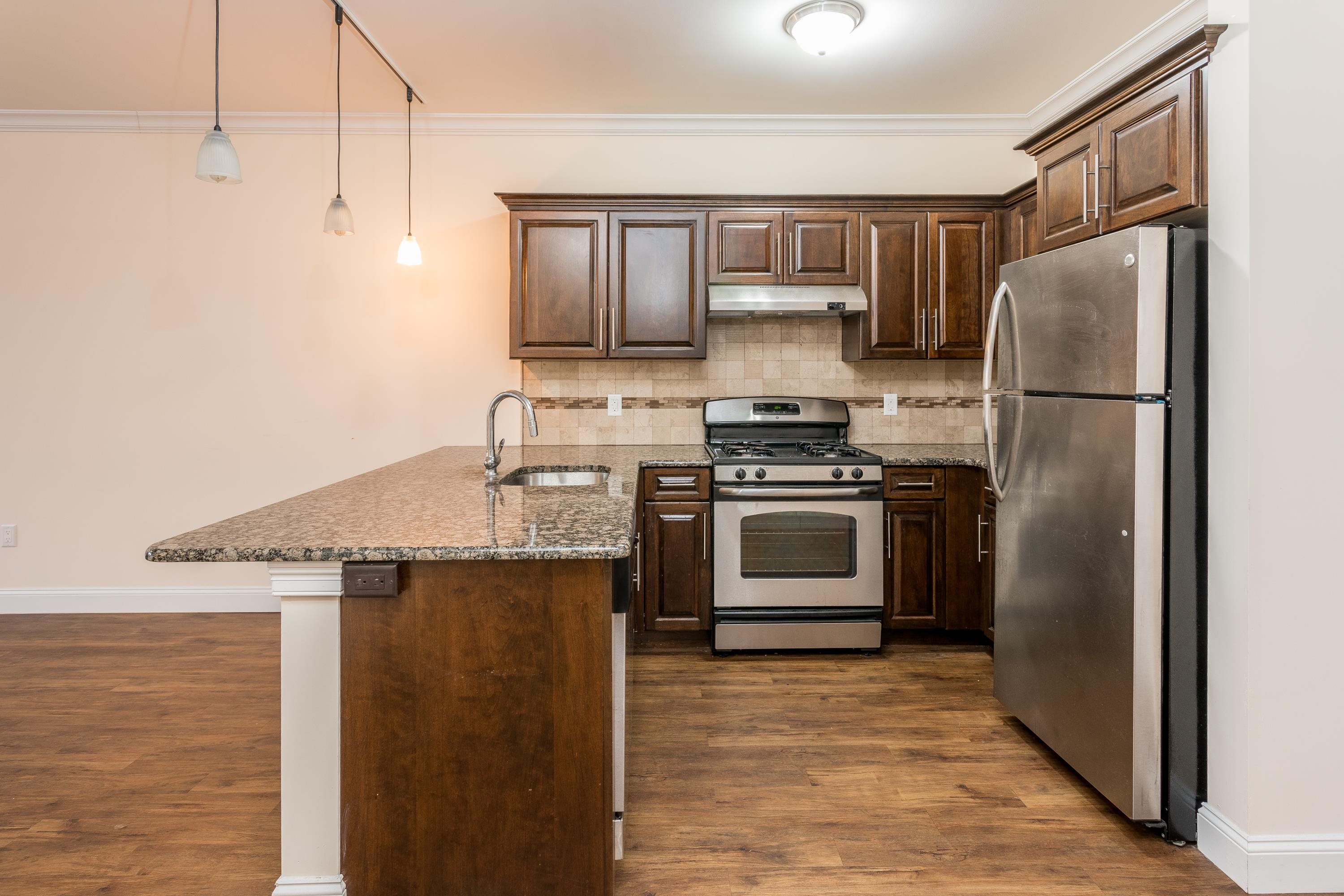 6111 Fillmore Place, Unit 306 West New York, NJ 07093 - Photo 25 of 27 a kitchen with stainless steel appliances a refrigerator stove and microwave