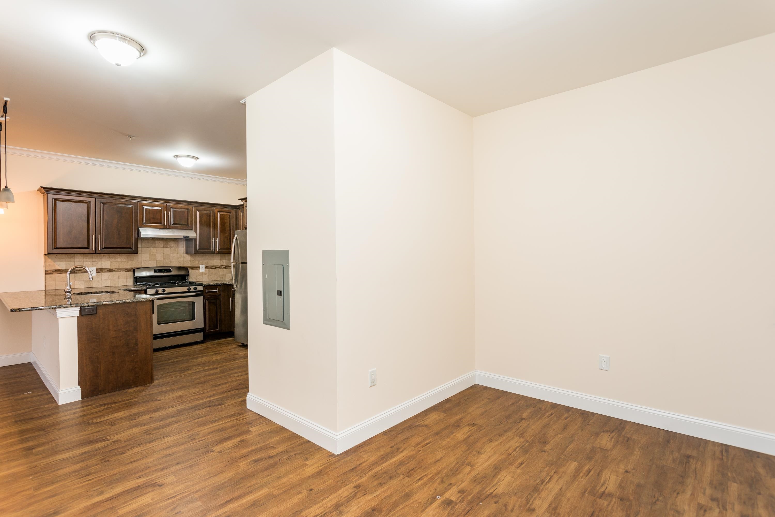 6111 Fillmore Place, Unit 306 West New York, NJ 07093 - Photo 9 of 27 a kitchen with a refrigerator and a stove top oven