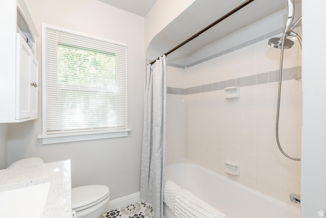 227 West 200 North Logan, UT 84321 - Photo 24 of 44 Bathroom featuring a white subway tile shower surround with a gray accent band, a built-in tub, and a chrome showerhead with a handheld sprayer