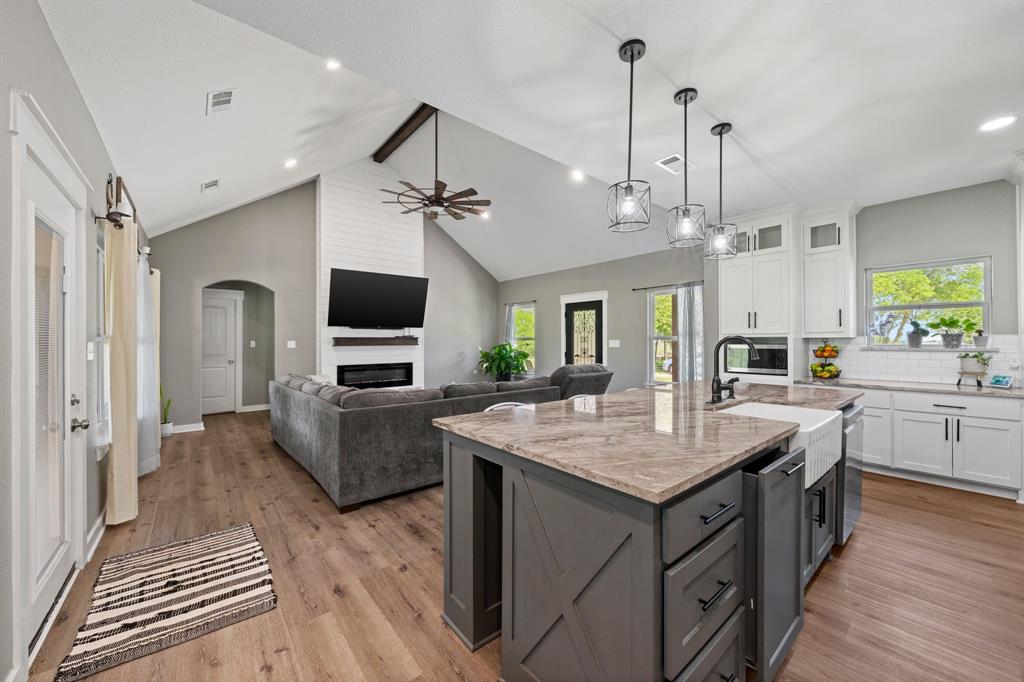 710 Valek Road Ennis, TX 75119 - Photo 13 of 40 a open kitchen with sink stove and refrigerator