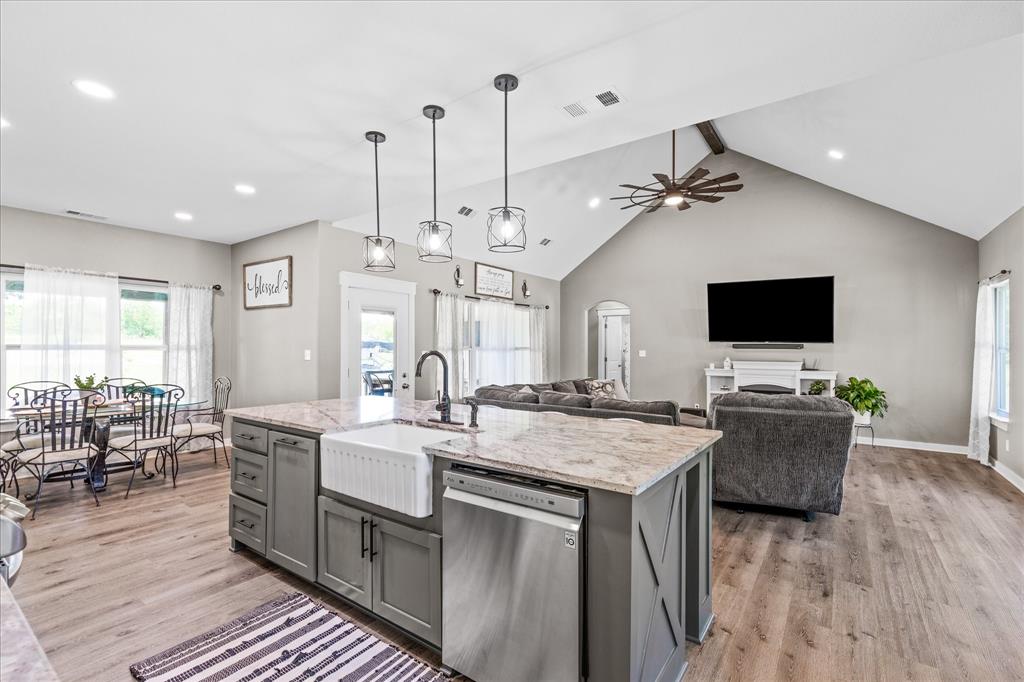 710 Valek Road Ennis, TX 75119 - Photo 17 of 40 a large kitchen with sink and a stove top oven