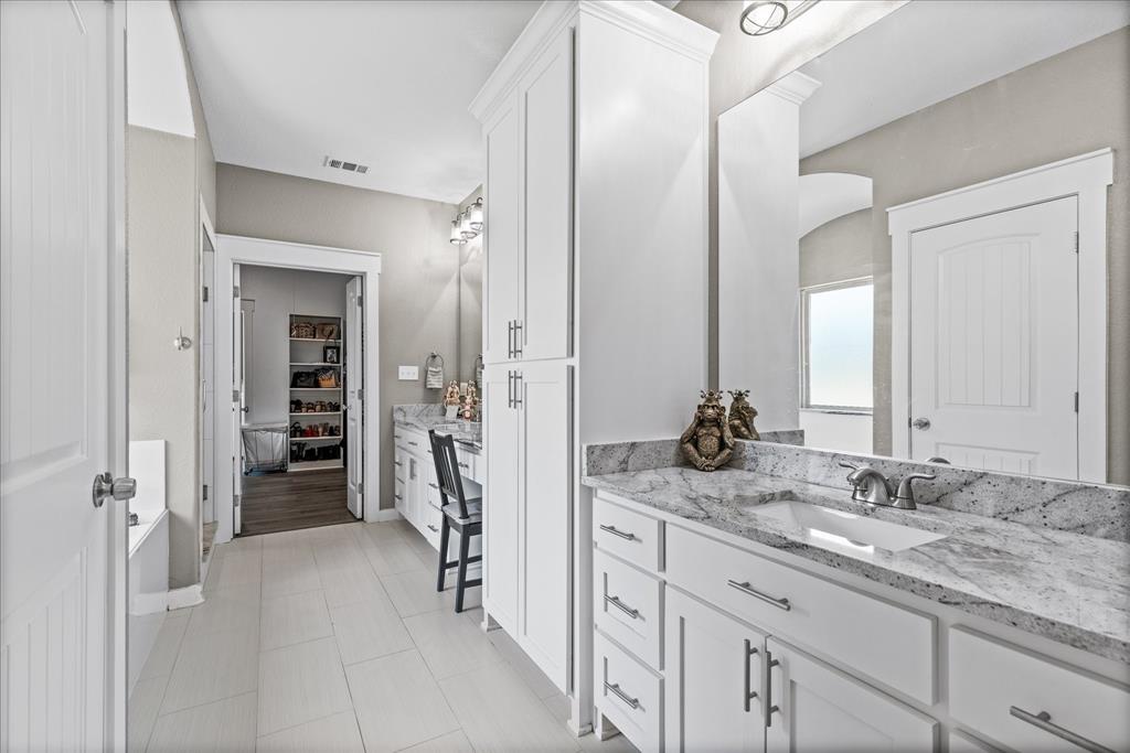710 Valek Road Ennis, TX 75119 - Photo 25 of 40 a en suite bathroom with double sink and a mirror
