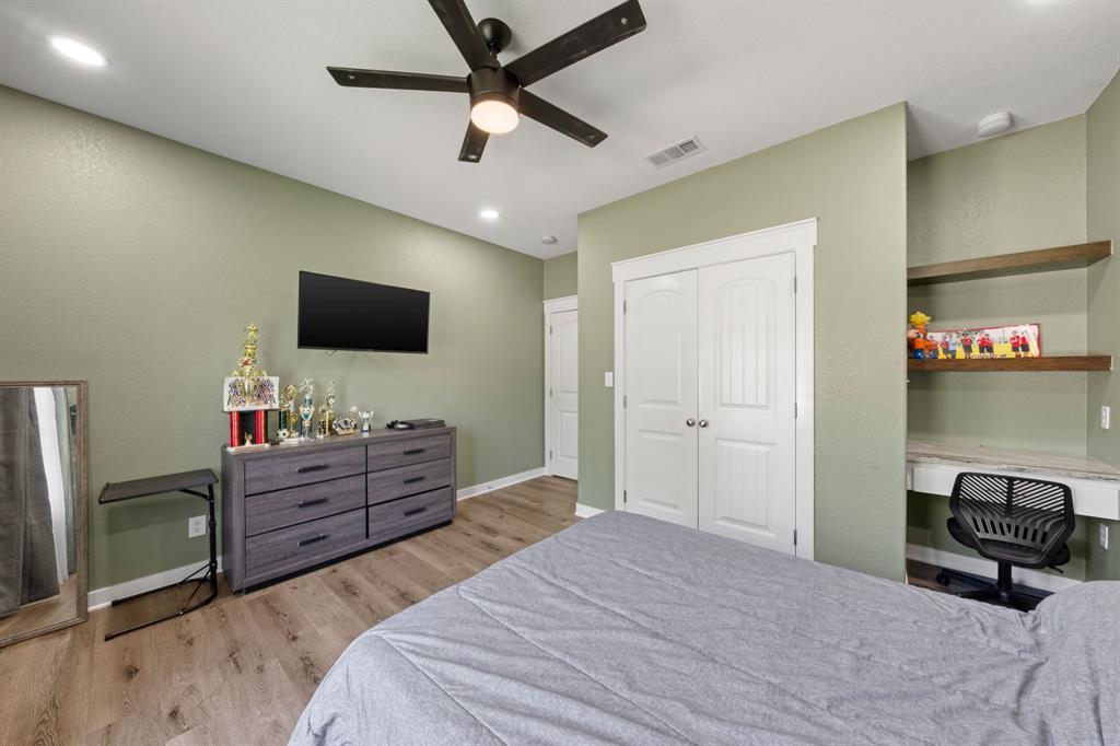 710 Valek Road Ennis, TX 75119 - Photo 29 of 40 a bedroom with a bed and a flat screen tv
