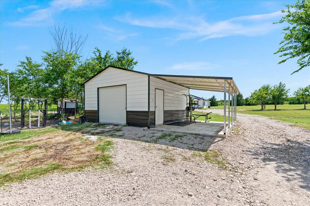710 Valek Road Ennis, TX 75119 - Photo 35 of 40 a view of a house with backyard and trees
