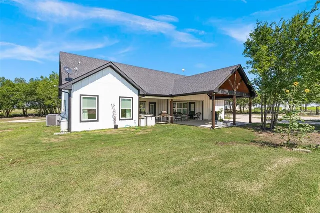 a front view of house with yard and green space