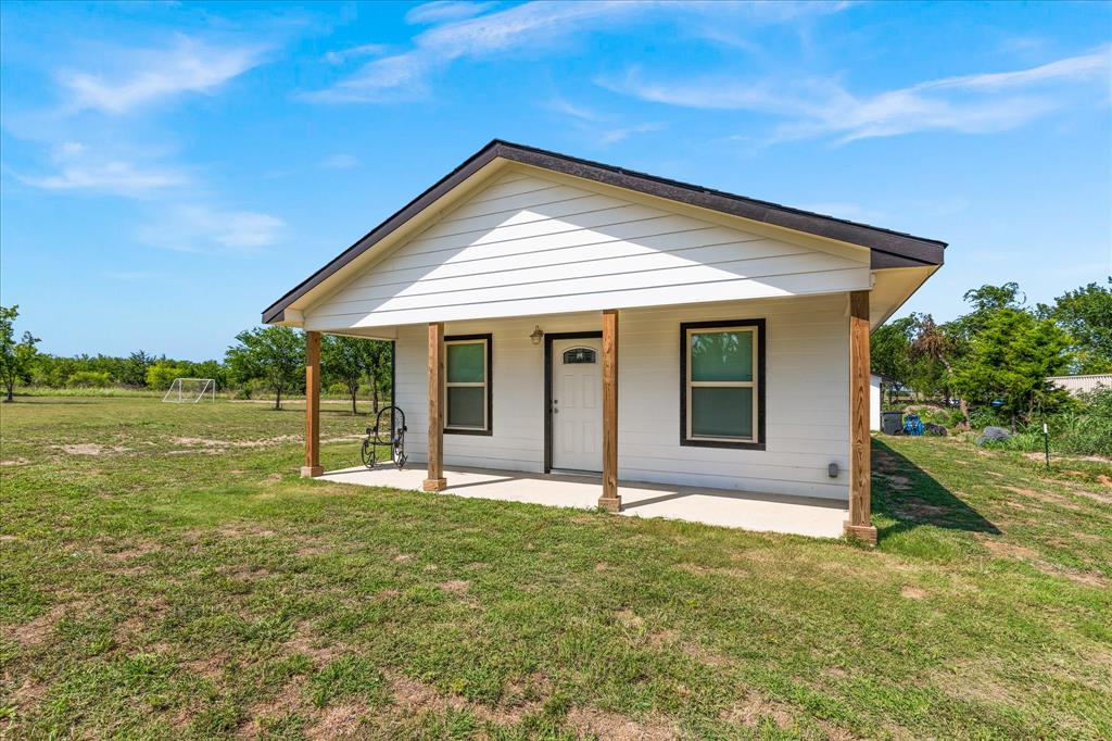 710 Valek Road Ennis, TX 75119 - Photo 38 of 40 a front view of house with yard and green space