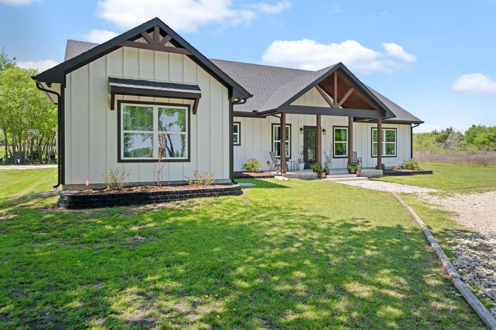 710 Valek Road Ennis, TX 75119 - Photo 5 of 40 a front view of a house with a yard