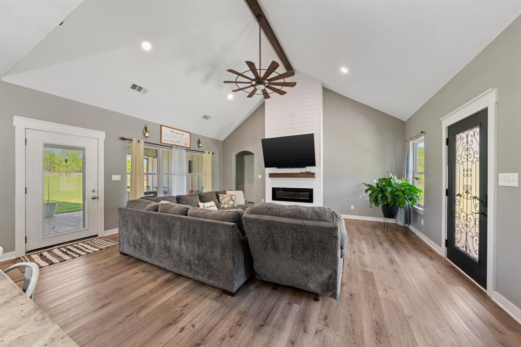 710 Valek Road Ennis, TX 75119 - Photo 8 of 40 a living room with furniture and a flat screen tv