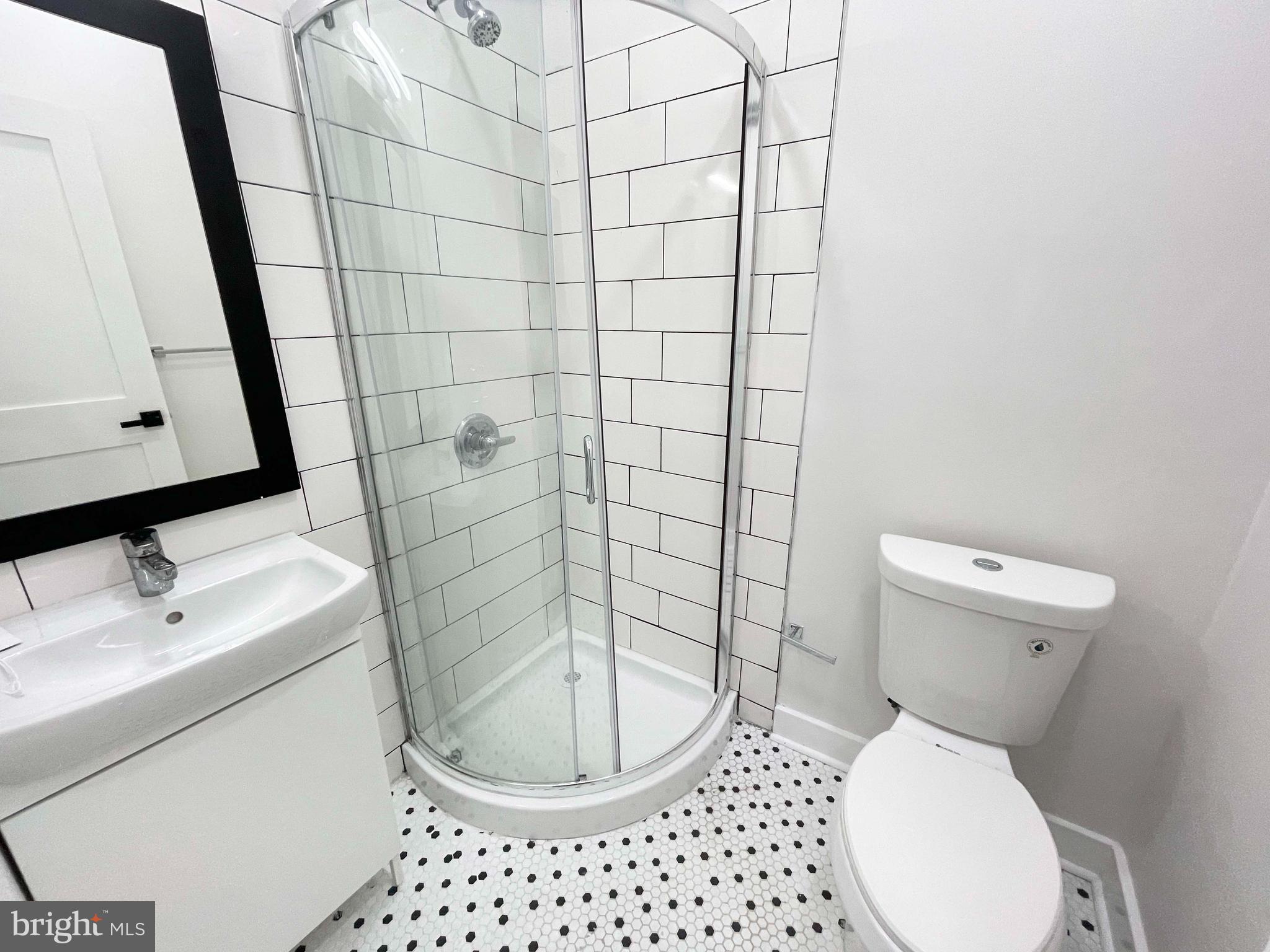 309 South 60th Street, Unit 1 Philadelphia, PA 19143 - Photo 14 of 17 a bathroom with a toilet and a sink