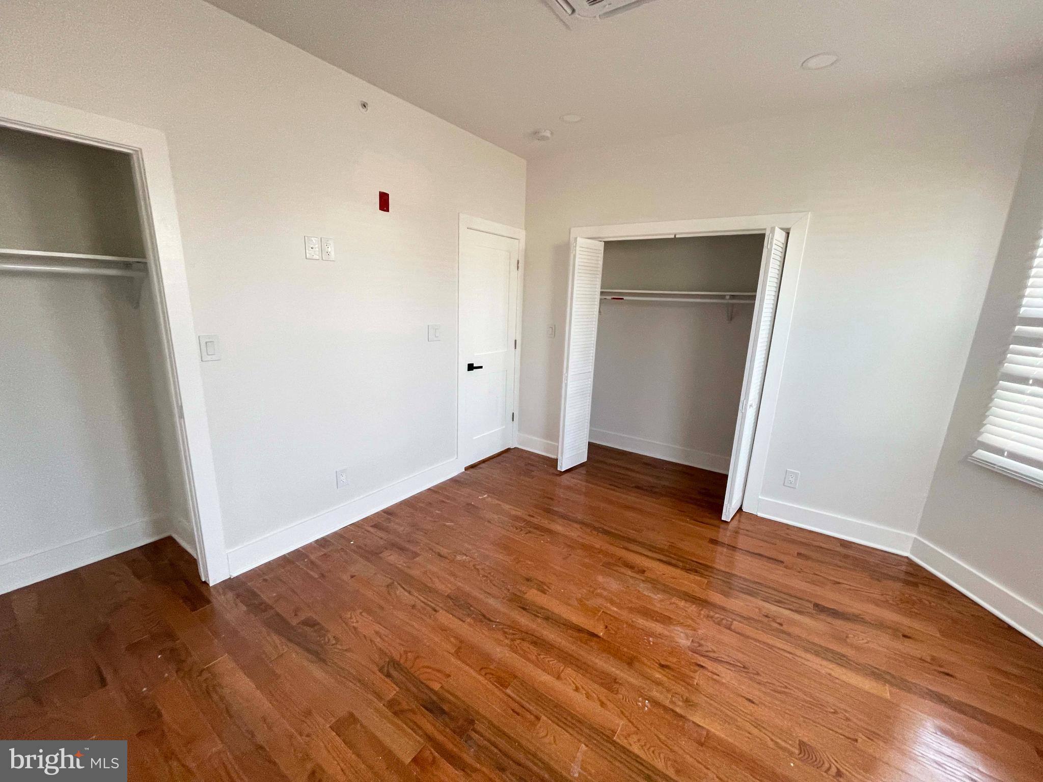 309 South 60th Street, Unit 1 Philadelphia, PA 19143 - Photo 5 of 17 an empty room with wooden floor and closet