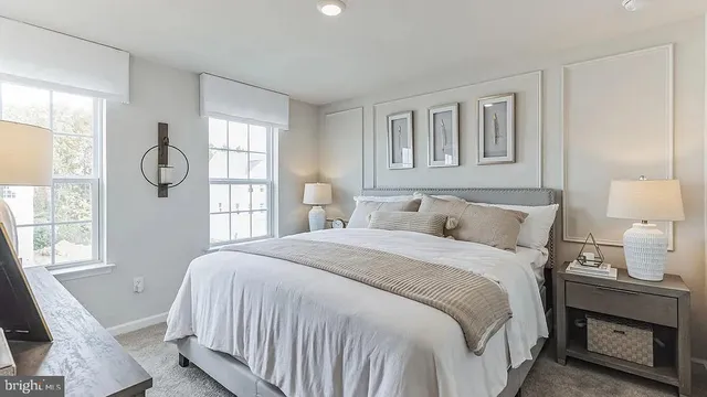 a bedroom with a bed a mirror and a window