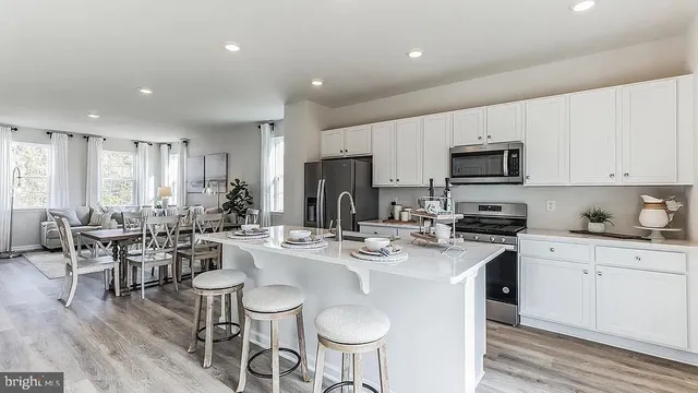 a kitchen with sink a microwave and cabinets