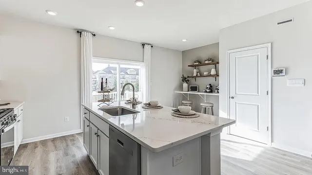 a kitchen with sink cabinets and wooden floor