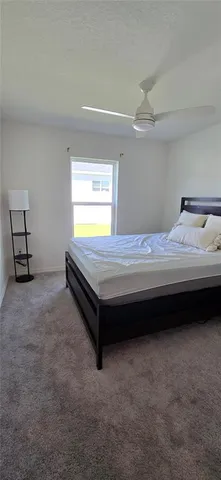 a bedroom with bed and a ceiling fan