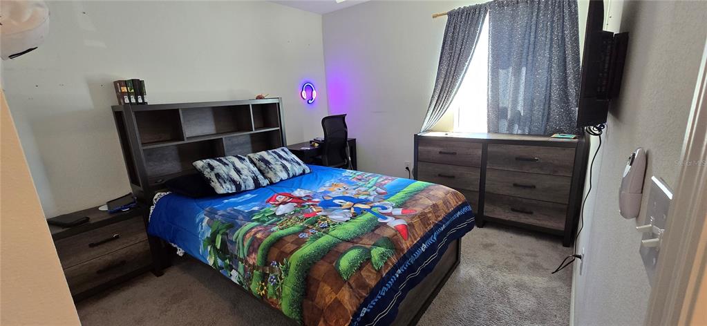 1446 Geranium Drive Mascotte, FL 34753 - Photo 15 of 24 a bedroom with a bed and a window