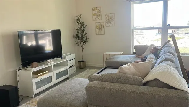 a living room with furniture and a flat screen tv