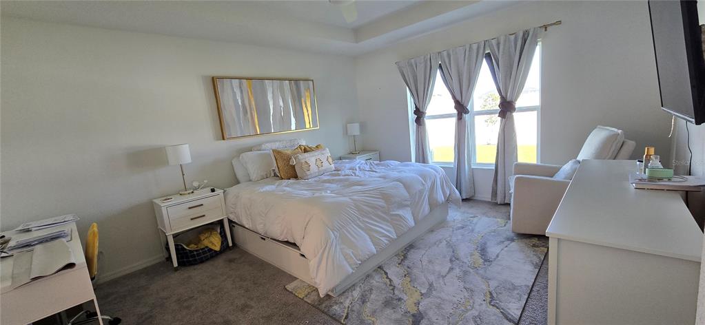 1446 Geranium Drive Mascotte, FL 34753 - Photo 7 of 24 a bedroom with a bed and a large window