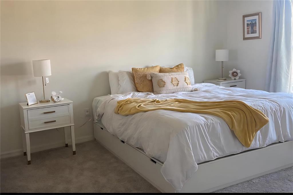 1446 Geranium Drive Mascotte, FL 34753 - Photo 9 of 24 a bedroom with a bed and a chair