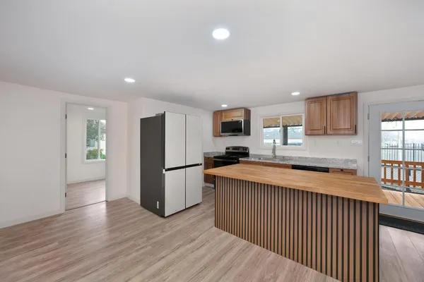 a kitchen with refrigerator and microwave