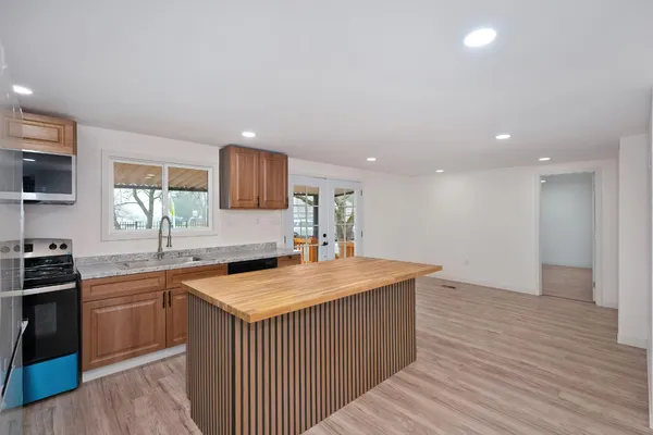 a kitchen with a sink cabinets and wooden floor