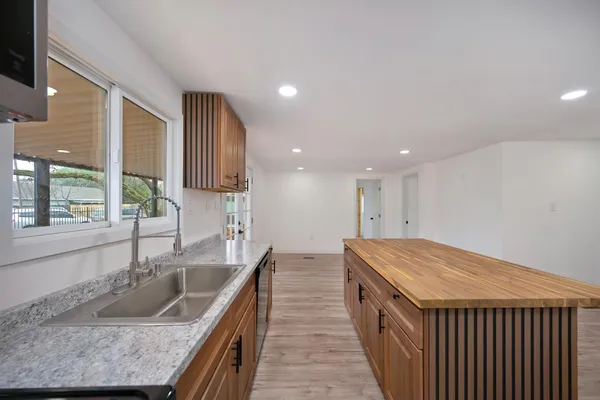 a kitchen with a sink stove and cabinets