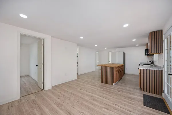 a room with a couch and a view of kitchen