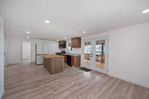 a large kitchen with stainless steel appliances granite countertop a large counter top and a stove top oven
