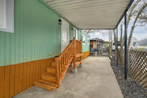 a view of a porch with wooden fence and stairs