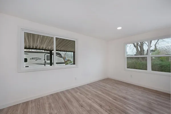 wooden floor in an empty room with a window