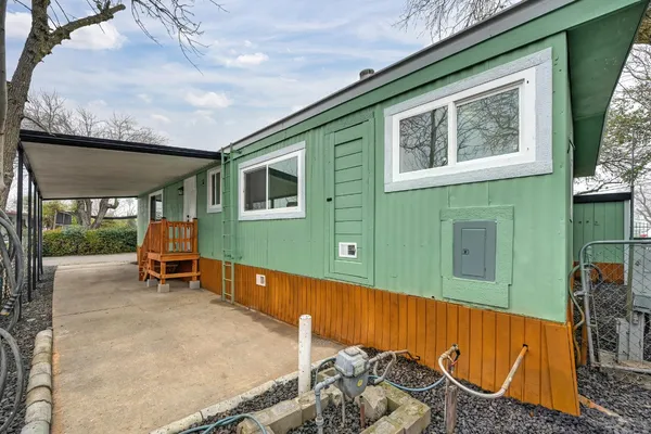 a backyard of a house with barbeque oven fire pit table and chairs
