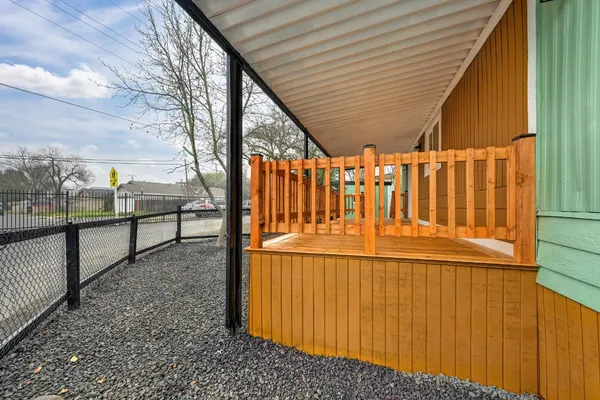 a view of entrance gate with wooden fence