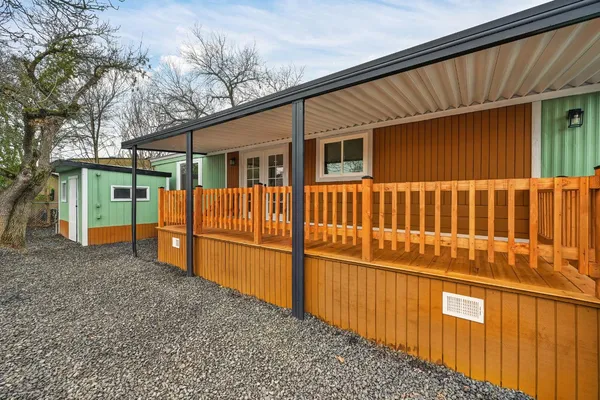 a view of a house with wooden fence