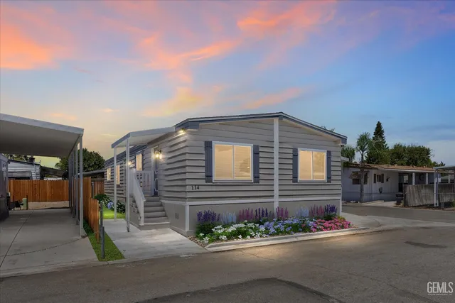 a brick house with a yard and parking space