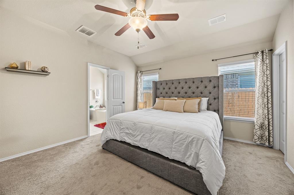 3010 Rosemount Lane Forney, TX 75126 - Photo 13 of 33 a bedroom with a bed and a chandelier