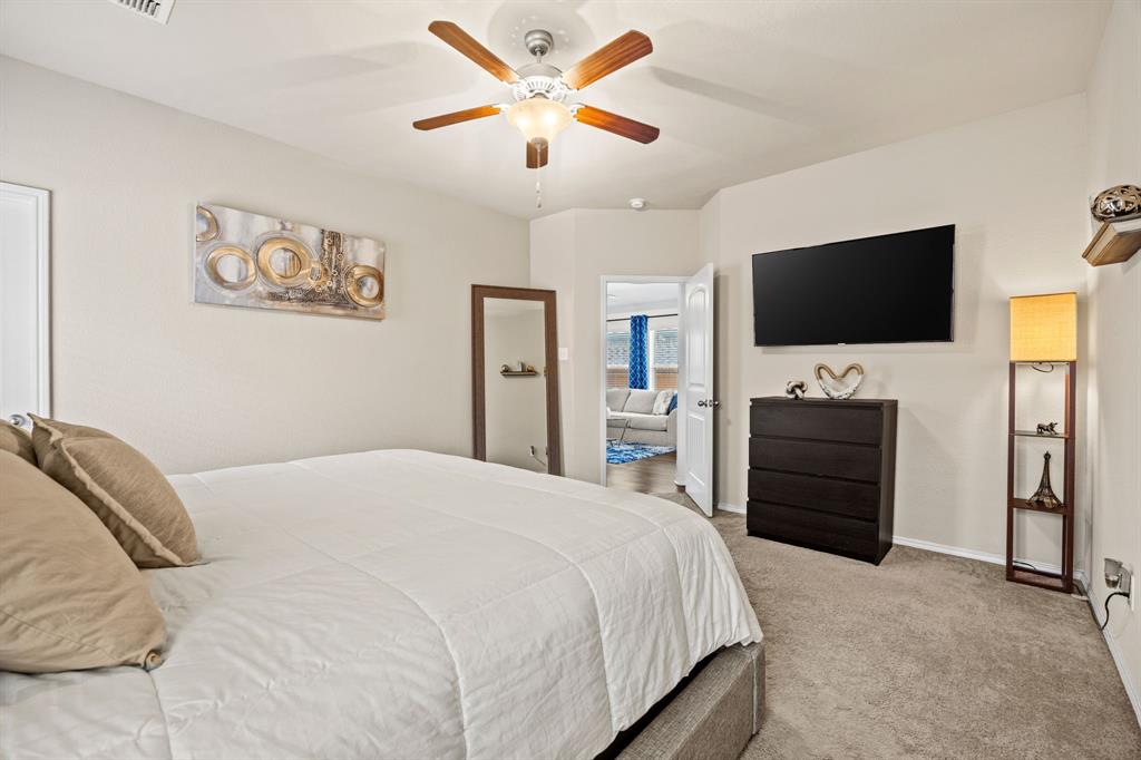 3010 Rosemount Lane Forney, TX 75126 - Photo 14 of 33 a bedroom with a bed and a flat screen tv
