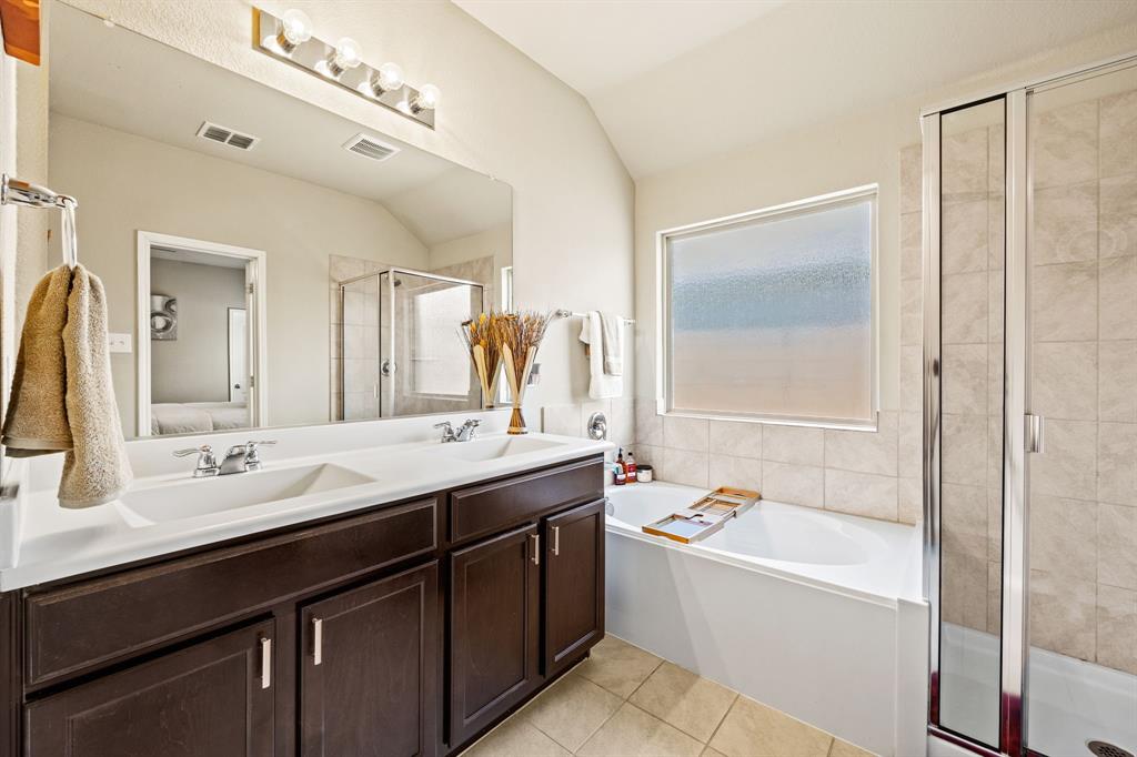 3010 Rosemount Lane Forney, TX 75126 - Photo 17 of 33 a bathroom with a granite countertop sink mirror and a bathtub