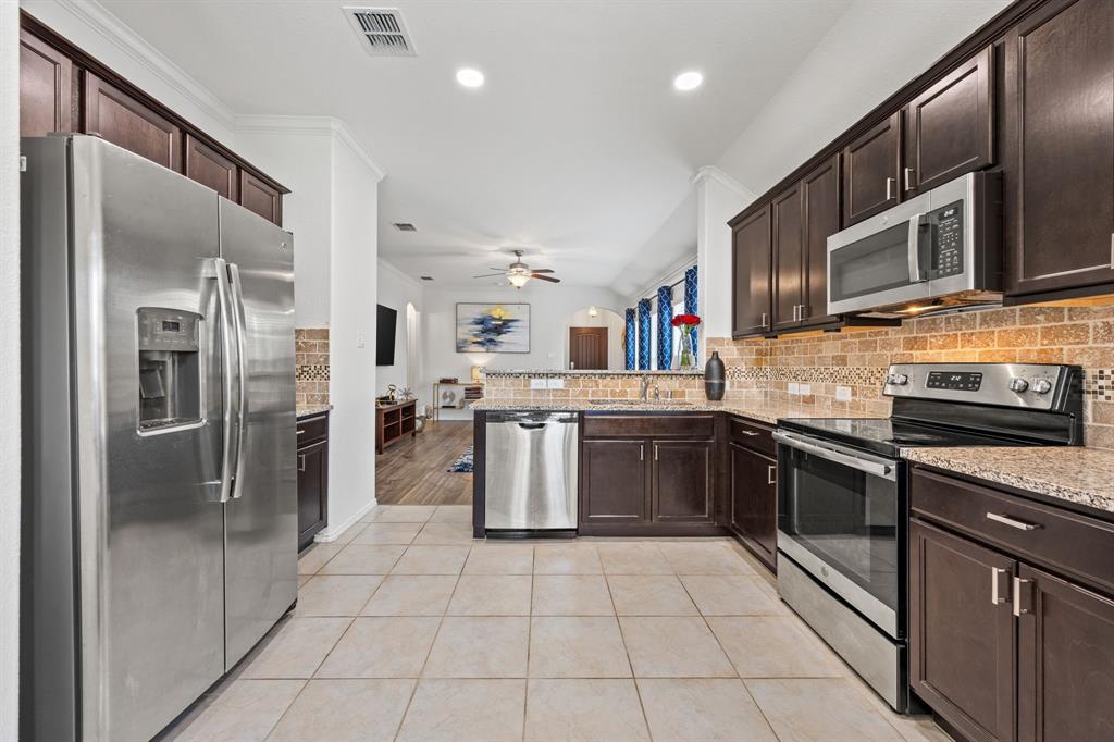 3010 Rosemount Lane Forney, TX 75126 - Photo 2 of 33 a kitchen with stainless steel appliances granite countertop a refrigerator and a stove top oven