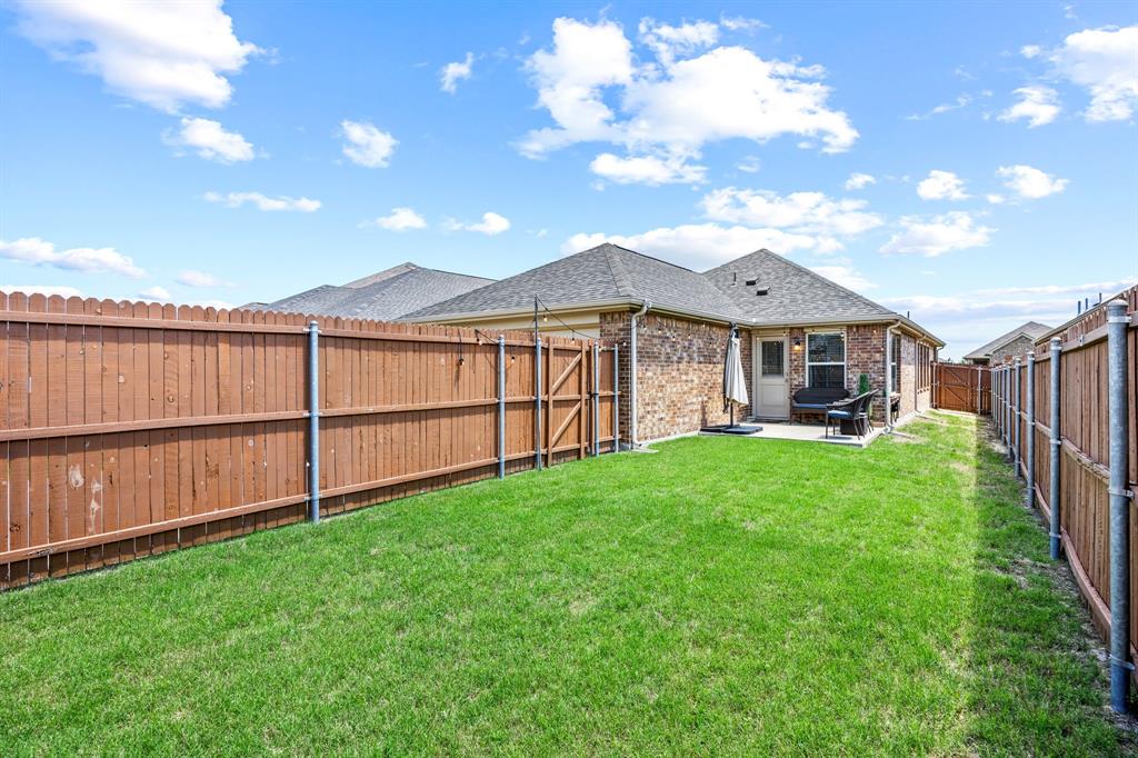 3010 Rosemount Lane Forney, TX 75126 - Photo 22 of 33 a view of a backyard with a garden and deck