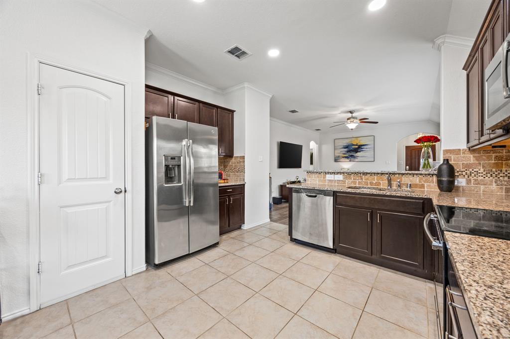 3010 Rosemount Lane Forney, TX 75126 - Photo 9 of 33 a kitchen with stainless steel appliances granite countertop a refrigerator and a sink