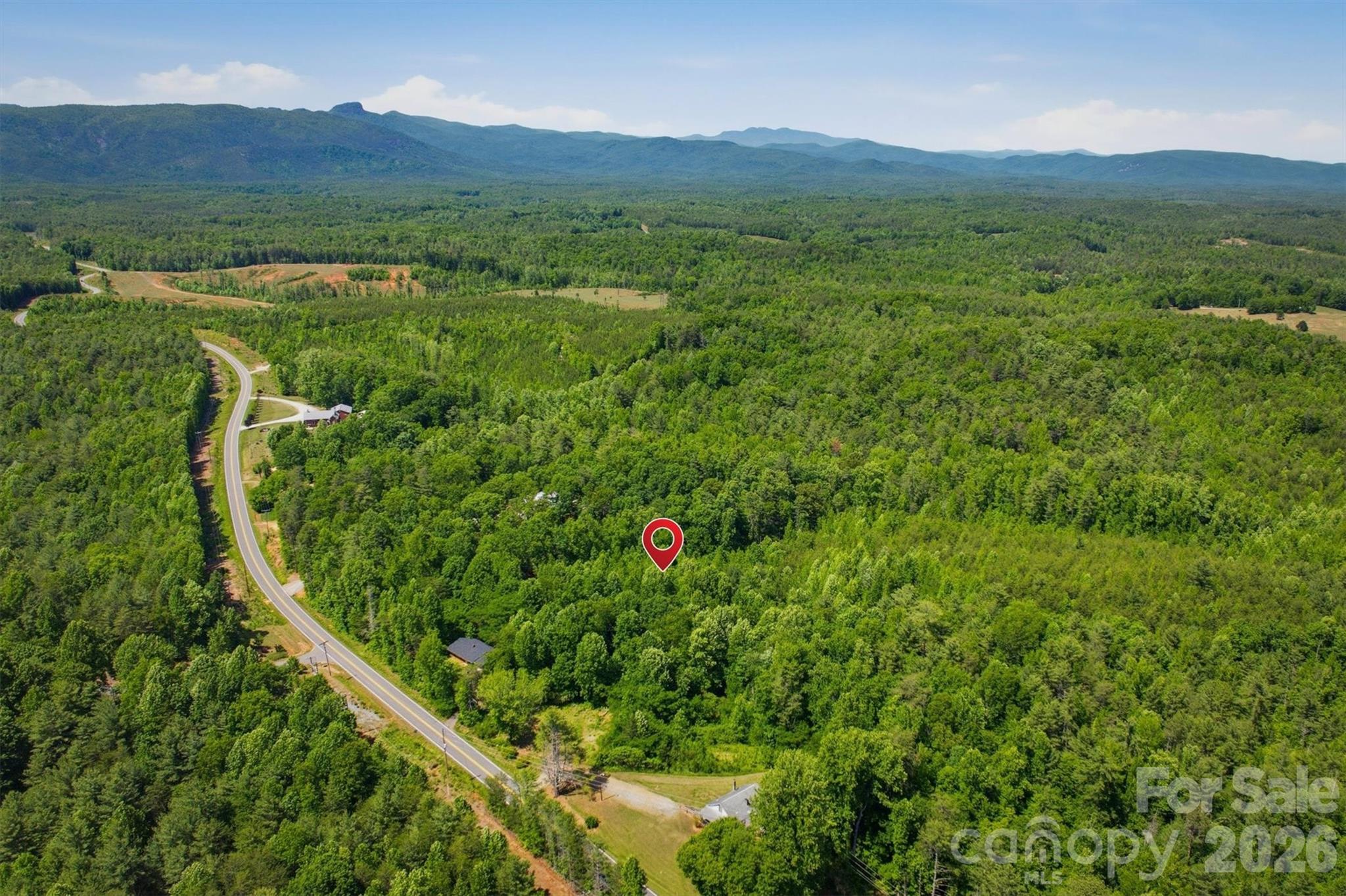 0 Nc 126 Road Morganton, NC 28655 - Photo 2 of 5 a view of a lush green hillside and a houses