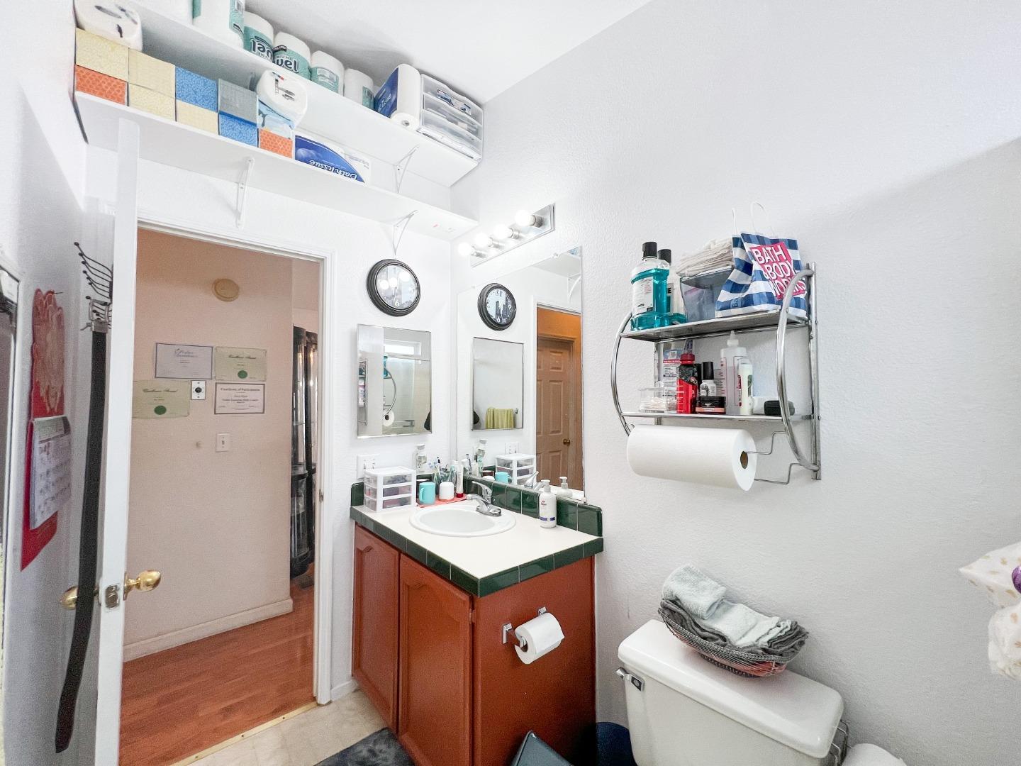 555 Umbarger Road, Unit 30 San Jose, CA 95111 - Photo 11 of 15 a bathroom with a sink vanity mirror and toilet
