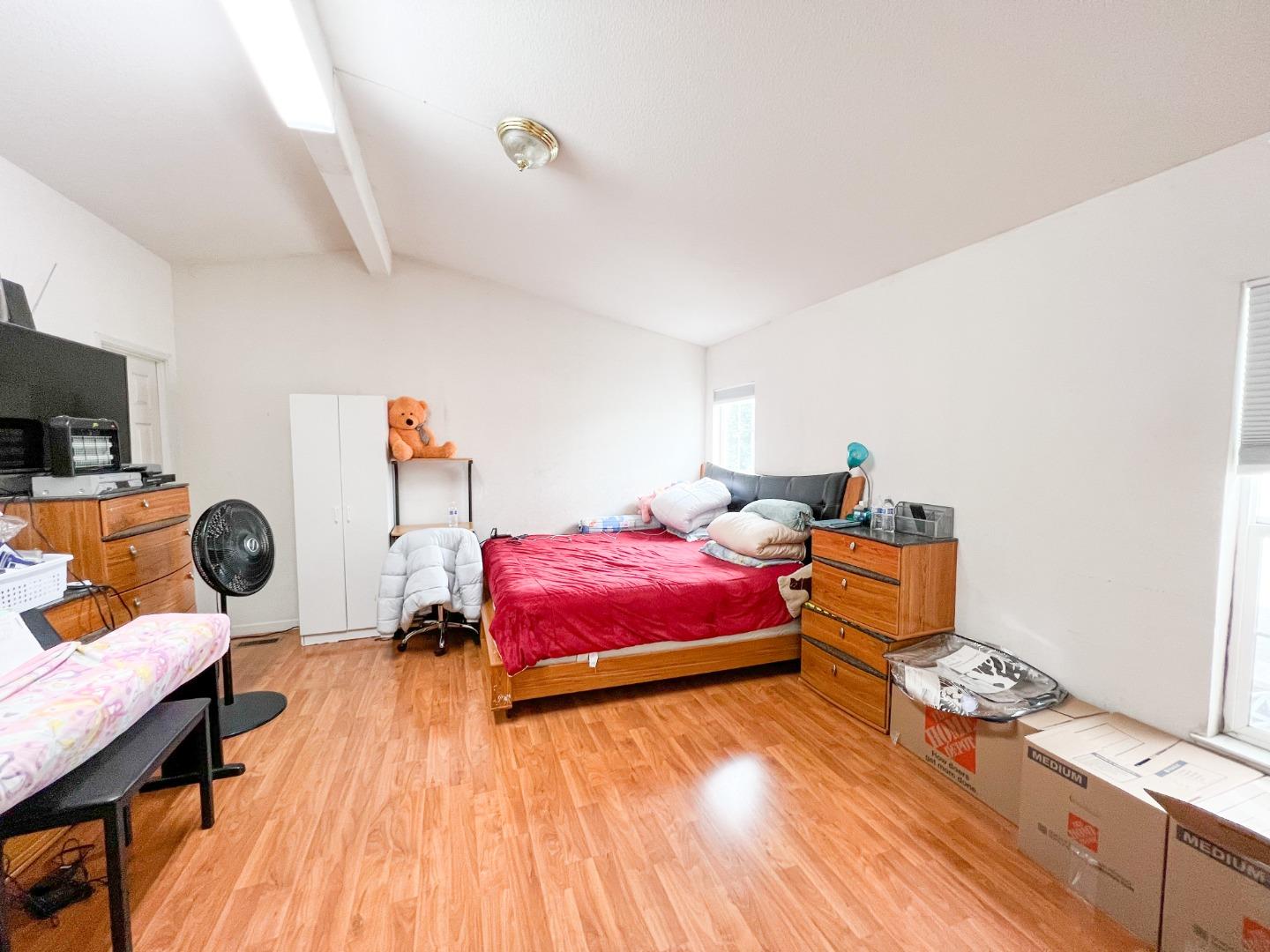 555 Umbarger Road, Unit 30 San Jose, CA 95111 - Photo 3 of 15 a bedroom with furniture and a wooden floor