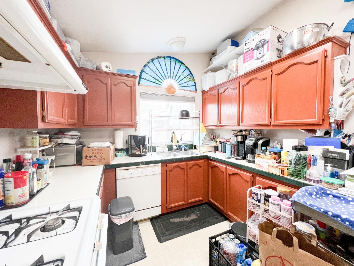 555 Umbarger Road, Unit 30 San Jose, CA 95111 - Photo 4 of 15 a kitchen with stainless steel appliances granite countertop a sink and cabinets