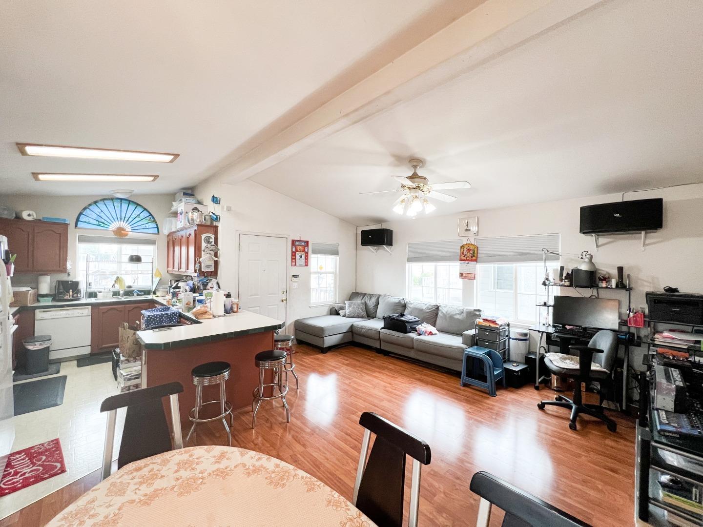 555 Umbarger Road, Unit 30 San Jose, CA 95111 - Photo 7 of 15 a living room with furniture kitchen view and a wooden floor