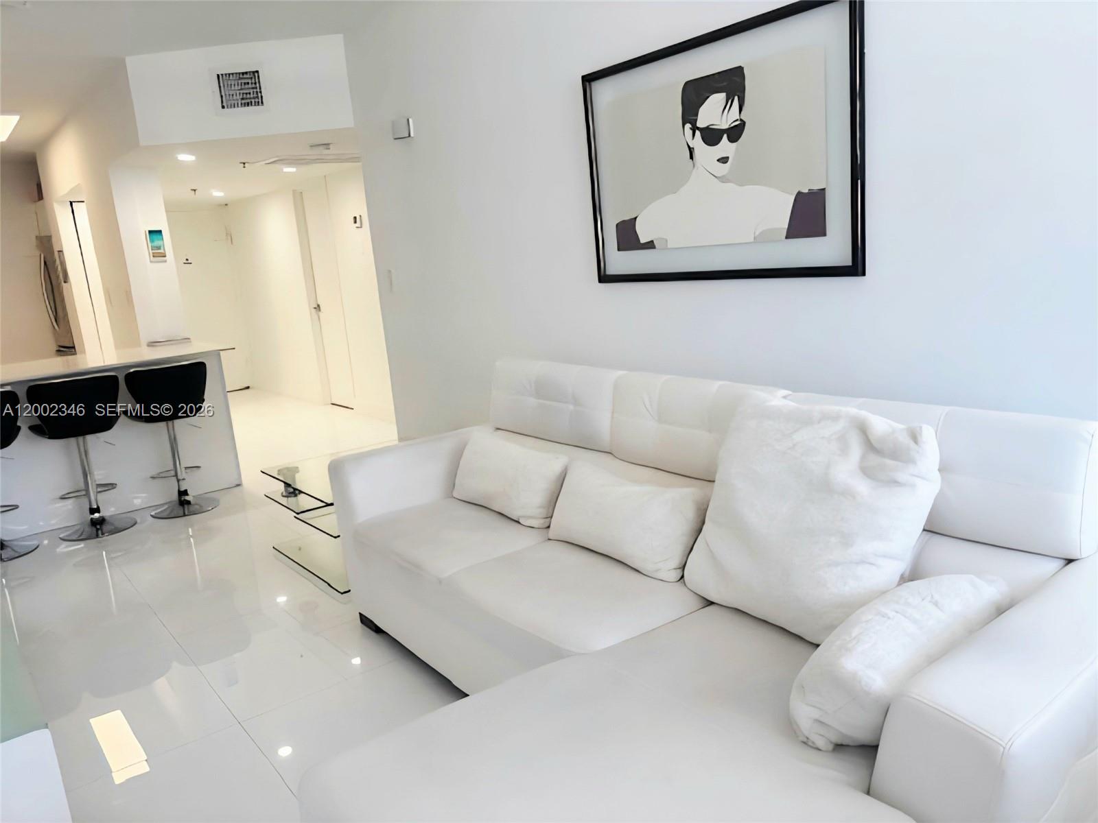a living room with furniture and white walls