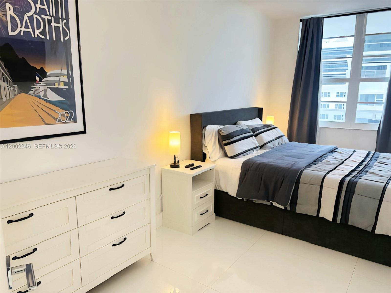 100 Lincoln Road, Unit 927 Miami Beach, FL 33139 - Photo 12 of 42 a bedroom with a bed and window