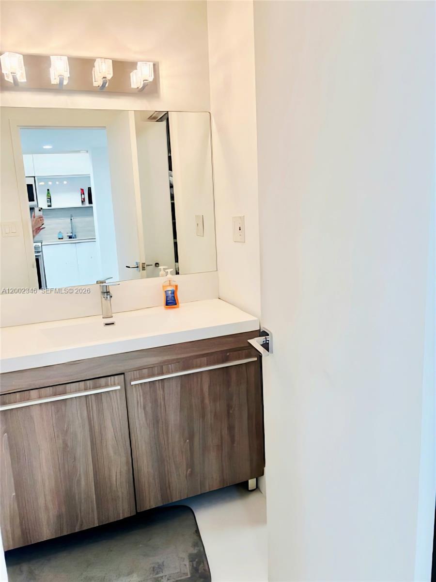 100 Lincoln Road, Unit 927 Miami Beach, FL 33139 - Photo 17 of 42 a bathroom with a sink and a mirror