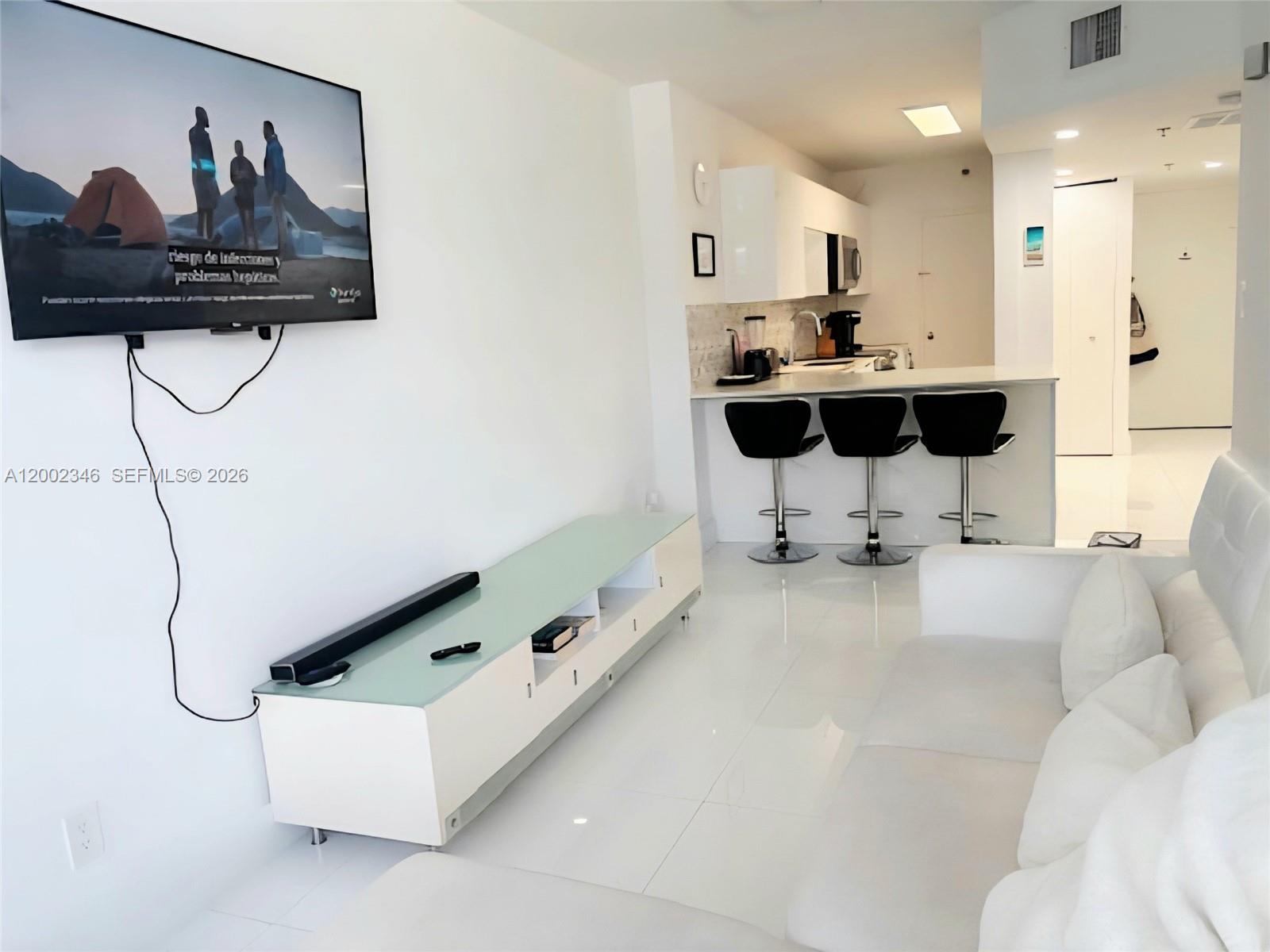 100 Lincoln Road, Unit 927 Miami Beach, FL 33139 - Photo 3 of 42 a living room with furniture and a table