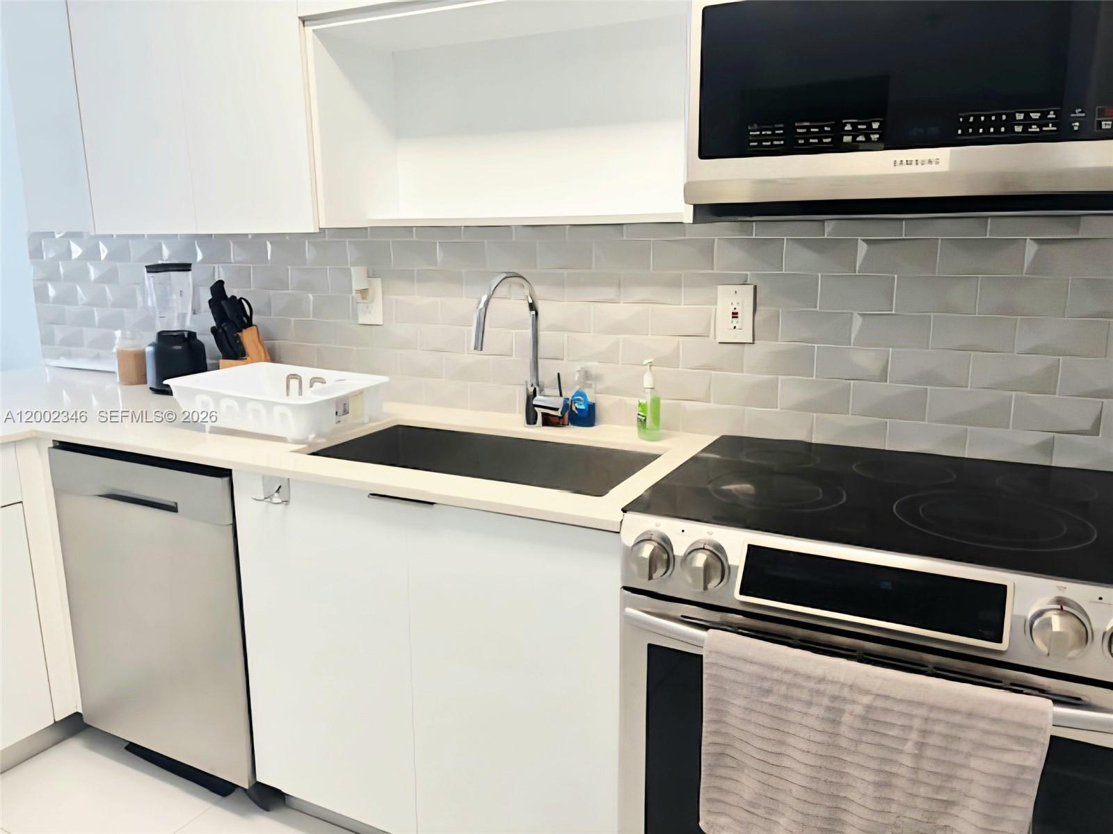 100 Lincoln Road, Unit 927 Miami Beach, FL 33139 - Photo 7 of 42 a kitchen with a sink and cabinets